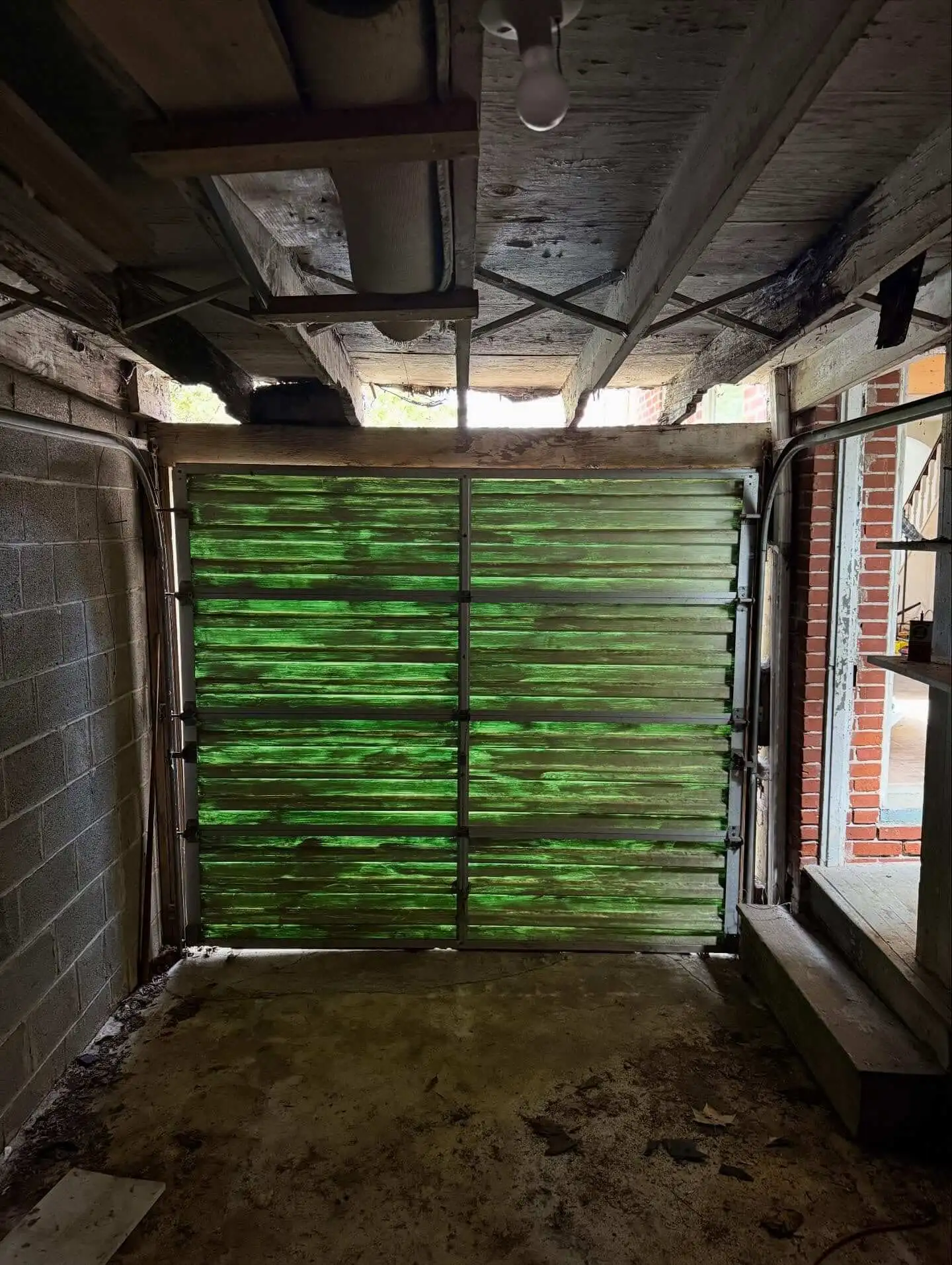 Interior view of a broken down garage before restoration
